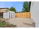Spacious backyard features a fence, storage shed, and a concrete area for outdoor activities at 871 S Worchester St, Aurora, CO 80012