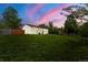 Lush backyard and charming home creating an inviting outdoor space with a beautiful sky at 871 S Worchester St, Aurora, CO 80012