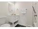 Elegant bathroom boasts black floors, modern vanity, and stylish fixtures at 871 S Worchester St, Aurora, CO 80012