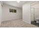 Carpeted bedroom next to a bathroom with a glass-enclosed shower and modern fixtures at 871 S Worchester St, Aurora, CO 80012