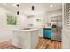Well-lit kitchen with a kitchen island, stainless steel appliances, and hardwood floors at 871 S Worchester St, Aurora, CO 80012