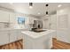 Modern kitchen with stainless steel appliances, quartz countertops, and a kitchen island at 871 S Worchester St, Aurora, CO 80012