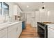 Bright kitchen with white cabinets, stainless steel appliances and hardwood flooring at 871 S Worchester St, Aurora, CO 80012