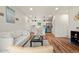 Open-concept living space with hardwood floors, a modern kitchen, and stylish furnishings at 871 S Worchester St, Aurora, CO 80012