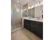 Elegant bathroom with glass-enclosed shower, dual sinks, and modern lighting fixtures at 1336 Sheridan Blvd # 108, Denver, CO 80214