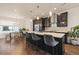 Modern kitchen with dark cabinetry, a large island, and stainless steel appliances at 1336 Sheridan Blvd # 108, Denver, CO 80214