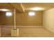 This spacious basement has carpet, paneled walls, a support column, and windows at 10759 Ogden St, Northglenn, CO 80233