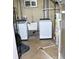 Basement laundry area with new washer, dryer, and utility sink at 10759 Ogden St, Northglenn, CO 80233