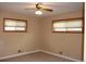 The bedroom has neutral walls and carpet, a ceiling fan, and windows for natural light at 10759 Ogden St, Northglenn, CO 80233