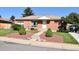 Charming brick home featuring manicured landscaping and a welcoming front entrance at 10759 Ogden St, Northglenn, CO 80233
