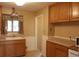 Functional kitchen with wooden cabinets and countertops, a classic sink, and tiled floors at 10759 Ogden St, Northglenn, CO 80233