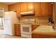 Well-equipped kitchen featuring oak cabinets, modern appliances, and a convenient layout at 10759 Ogden St, Northglenn, CO 80233