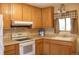 Well-equipped kitchen featuring oak cabinets, modern appliances, and a convenient layout at 10759 Ogden St, Northglenn, CO 80233