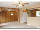 Open living room showcasing wood paneled walls, carpet floors, and arched doorway at 10759 Ogden St, Northglenn, CO 80233