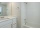 Well-lit bathroom with a white vanity, modern fixtures, and a shower-tub combo, offering a clean design at 9180 E 52Nd Dr, Denver, CO 80238
