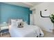 Stylish bedroom with a decorative blue accent wall, inviting textures, and elegant bedside tables at 9180 E 52Nd Dr, Denver, CO 80238