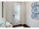 Bright entryway with a frosted glass door, stylish wall art, and dark wood flooring at 9180 E 52Nd Dr, Denver, CO 80238
