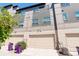 Exterior view of a modern townhome featuring attached garages and multi-tone siding at 9180 E 52Nd Dr, Denver, CO 80238