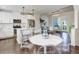 Bright kitchen, island with seating, stainless appliances, hardwood floors, open floor plan, and dining area at 9180 E 52Nd Dr, Denver, CO 80238