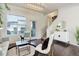 Bright living room with hardwood floors, contemporary decor, and access to the staircase at 9180 E 52Nd Dr, Denver, CO 80238