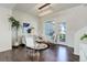 Bright living room with hardwood floors, modern lighting, and access to a balcony at 9180 E 52Nd Dr, Denver, CO 80238