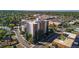 A high angle view shows the high rise condo with its brick and white exterior at 4570 E Yale Ave # 1004, Denver, CO 80222