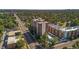 A view of the high rise condo, pool, adjacent condos, and a busy street at 4570 E Yale Ave # 1004, Denver, CO 80222