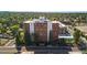 A high angle view highlights the building and its location in a lush, tree-filled community at 4570 E Yale Ave # 1004, Denver, CO 80222