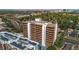 A great view of the condo building, its swimming pool, and an adjacent building with solar panels at 4570 E Yale Ave # 1004, Denver, CO 80222
