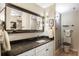 This is a modern bathroom with a large mirror, updated fixtures, and a neutral color palette at 4570 E Yale Ave # 1004, Denver, CO 80222