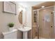 A pedestal sink and glass shower complete this modern bathroom at 4570 E Yale Ave # 1004, Denver, CO 80222