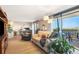 This light filled living room features an outdoor balcony and warm decor at 4570 E Yale Ave # 1004, Denver, CO 80222