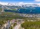 Stunning aerial view showcasing a mountain resort nestled among lush forests with snow-capped mountains in the backdrop at 10 River Park Dr # A, Breckenridge, CO 80424