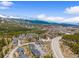 Breathtaking aerial perspective of residences in a mountain setting featuring snow-covered peaks and lush greenery at 10 River Park Dr # A, Breckenridge, CO 80424