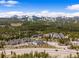 Overhead aerial of wooded mountain residences with tree coverage and a snowy mountain view in the distance at 10 River Park Dr # A, Breckenridge, CO 80424