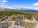 Aerial view of a mountain condo complex surrounded by lush green forests and snow-capped mountain peaks at 10 River Park Dr # A, Breckenridge, CO 80424