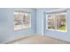 Bright, carpeted bedroom with two large windows providing natural light and neighborhood views at 10 River Park Dr # A, Breckenridge, CO 80424