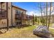 Exterior rear view of the home with a well-manicured lawn and mature trees at 10 River Park Dr # A, Breckenridge, CO 80424