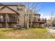 Exterior side view of the home with a well-manicured lawn and mature trees at 10 River Park Dr # A, Breckenridge, CO 80424