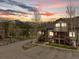 Inviting mountain condo with wood siding, private balconies, and stunning views of snowy peaks at sunset at 10 River Park Dr # A, Breckenridge, CO 80424