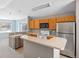 Bright kitchen features stainless steel refrigerator and wooden cabinetry at 10 River Park Dr # A, Breckenridge, CO 80424