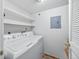 Bright laundry room featuring a washer and dryer with overhead storage shelves at 10 River Park Dr # A, Breckenridge, CO 80424