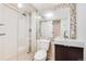 Modern bathroom with tiled shower, and a wall mounted sink over a dark wooden cabinet at 9811 Gatesbury Cir, Highlands Ranch, CO 80126