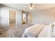 Bright bedroom featuring neutral walls and carpet with a walk-in closet and an adjoining bathroom at 9811 Gatesbury Cir, Highlands Ranch, CO 80126