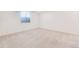 Neutral-toned bedroom featuring a large window, neutral carpet, and bright white walls at 9811 Gatesbury Cir, Highlands Ranch, CO 80126