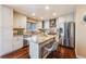 Modern kitchen featuring granite countertops, stainless steel appliances, white cabinets and island with seating at 9811 Gatesbury Cir, Highlands Ranch, CO 80126