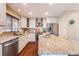 Modern kitchen featuring granite countertops, stainless steel appliances, white cabinets and island with seating at 9811 Gatesbury Cir, Highlands Ranch, CO 80126