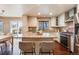 Modern kitchen with granite countertops, stainless steel appliances, white cabinets, an island, and hardwood floors at 9811 Gatesbury Cir, Highlands Ranch, CO 80126