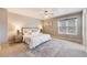 Bedroom with a neutral color scheme, plush carpeting, natural light, and a cozy ambiance at 9811 Gatesbury Cir, Highlands Ranch, CO 80126