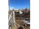 Backyard featuring a wooden fence, utility poles and a small detached garage in the distance at 1130 Orchard St, Golden, CO 80401